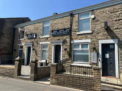 Two connected stone buildings with signs reading 